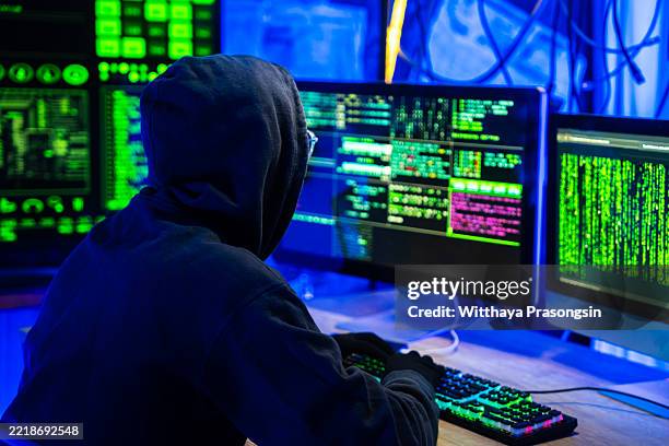 hooded hacker breaking into corporate network security system - cyber war stock pictures, royalty-free photos & images