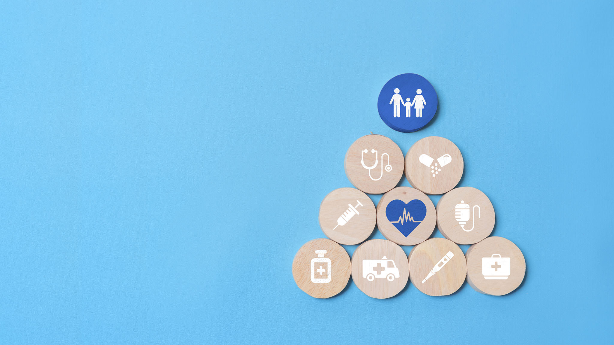 Health insurance concept, wooden blocks with healthcare medical icon on blue background Health insurance concept, wooden blocks with healthcare medical icon on blue background