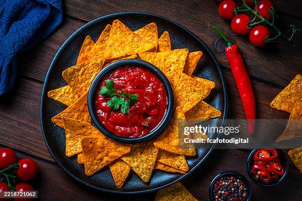nacho chips and salsa shot from above on wooden table - tortilla chip stock pictures, royalty-free photos & images