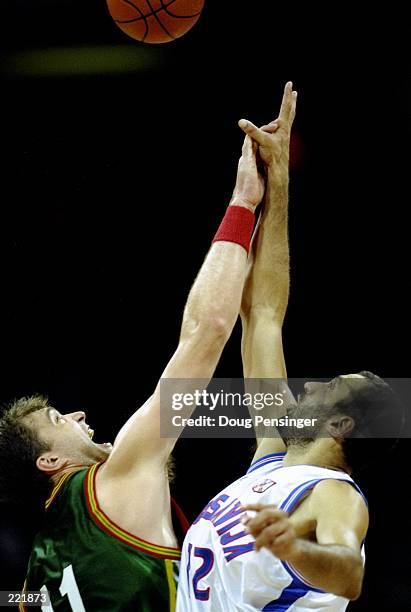 Vlade Divac of Yugoslavia, right, battles with Arturas Karnisovas of Lithuania, left, at the Georgia Dome at the 1996 Centennial Olympic Games in...