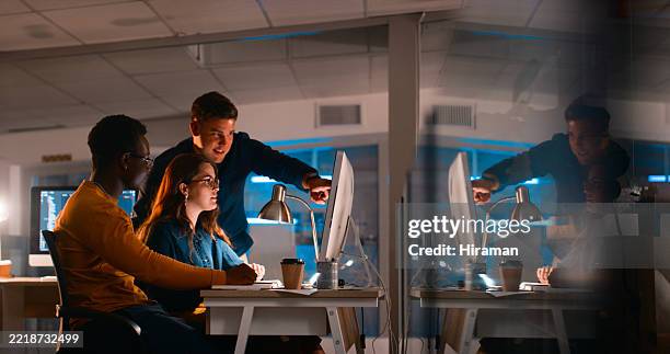 young professionals collaborating on coding project in modern office during night - wetenschappelijk onderzoek stockfoto's en -beelden