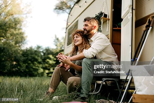 couple enjoying camping - motor home stock pictures, royalty-free photos & images