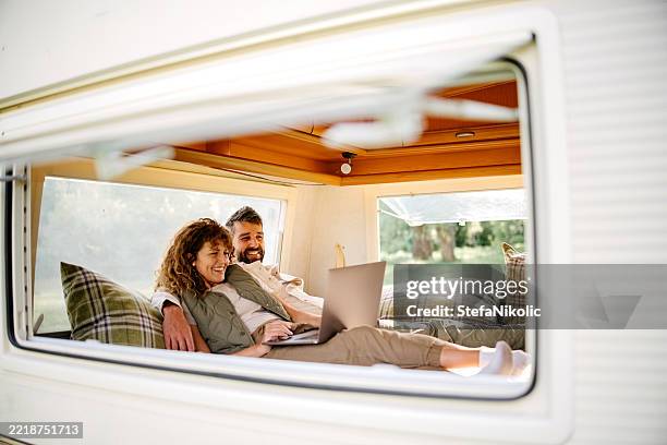 couple camping in a van - caravan stockfoto's en -beelden