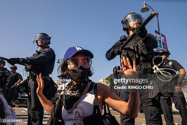 Protesters clash with law enforcement officers in the streets surrounding the federal building during a protest following federal immigration...