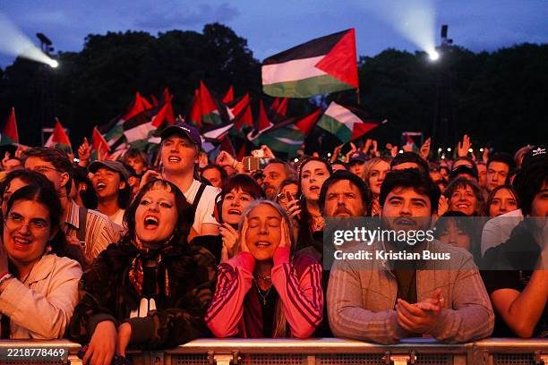 Palestinian flags are seen in the crowd as Massive Attack play live at the Lido music Festival in Victoria Park on the 6th of June 2025, London,...