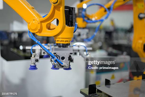 multi-axis automation using robotics synchronized working on precision metal components robotic arms for complex metalworking tasks in intelligent production line - vietnam business stock pictures, royalty-free photos & images
