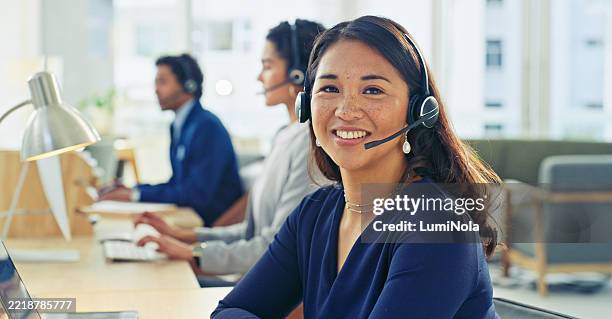 young professionals working in modern office with headsets - kundservicerepresentant bildbanksfoton och bilder