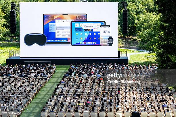 Attendees watch the keynote address during the Apple Worldwide Developers Conference at Apple Park campus in Cupertino, California, US, on Monday,...