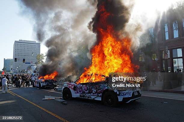 June 09: Waymo cars are set on fire and vandalized during a protest against immigration raids on June 08, 2025 in Los Angeles, California. Tensions...