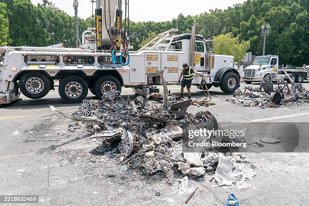 Workers clear burned Waymo cars in Los Angeles, California, US, on Monday, June 9, 2025. Tensions flared in Los Angeles on the third day of...