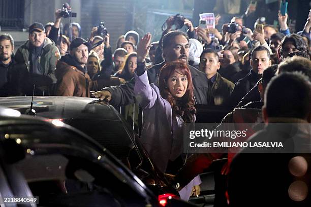 Argentina's former President Cristina Fernandez de Kirchner waves to supporters as she arrives at the Partido Justicialista headquarters in Buenos...