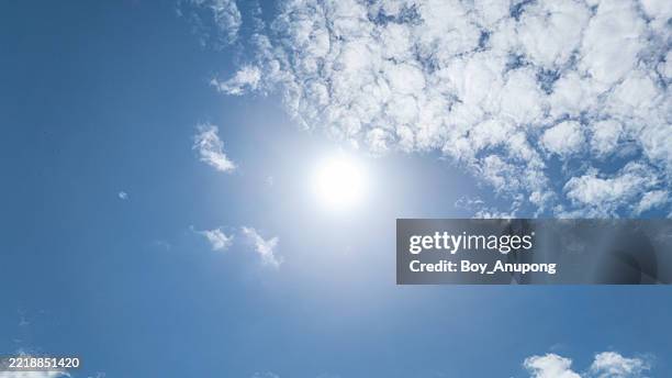 scenery view of the midday sun against blue sky. its maximum intensity and brightness, typically resulting in warm temperatures and strong shadows. - sun radiation stock pictures, royalty-free photos & images