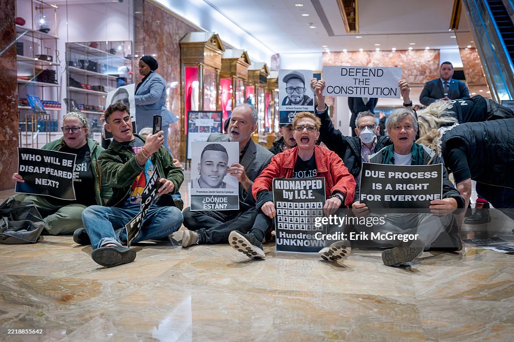 Participants seen holding signs at the protest. Around 30...