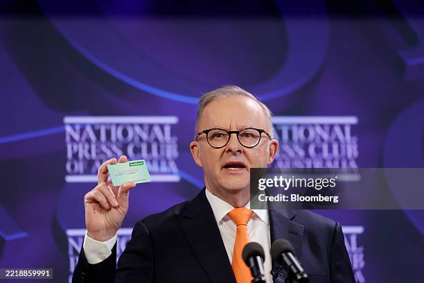 Anthony Albanese, Australia's prime minister, holds up a Medicare card during an address at the National Press Club in Canberra, Australia, on...