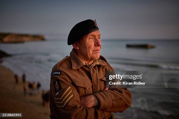 Royal Signal historical reenactor Dave Perrott from Essex, whose uncle landed on Sword Beach during the D-Day landings, watches the sunrise on Gold...