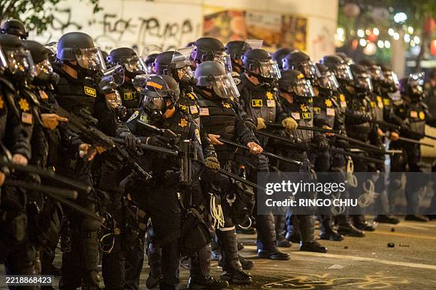 Police officers in riot stand during a demonstration following federal immigration operations in Los Angeles on June 9, 2025. President Donald...