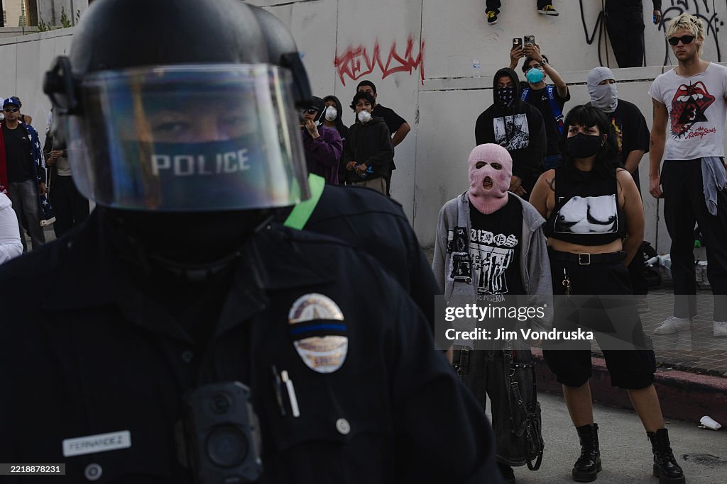 Police Riot Raid Protesters yell at police officers in riot gear outside of the Edward ...