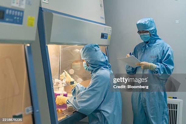 Technicians work inside a production laboratory for CAR-T cell therapies at the IASO Biotechnology Co. Facility in Nanjing, China, on Monday, June 9,...