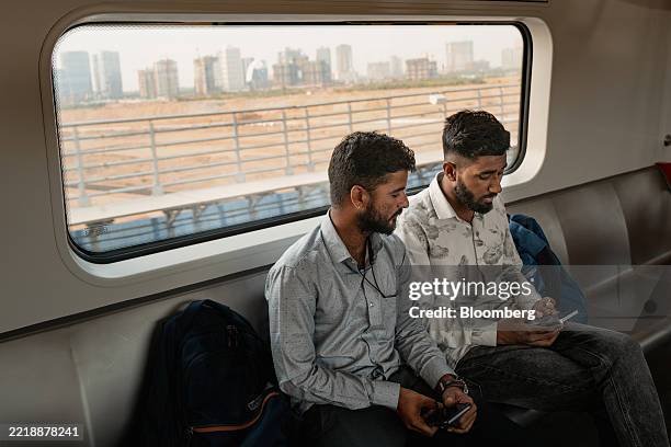 Passengers ride on a subway train in Gujarat International Finance Tec-City in the suburbs of Ahmedabad, Gujarat, India, on Wednesday, May 21, 2025....