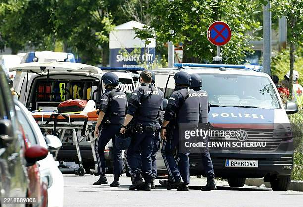 Policemen are seen in a street close to a school where, according to reports, several people died in a shooting, on June 10, 2025 in Graz,...