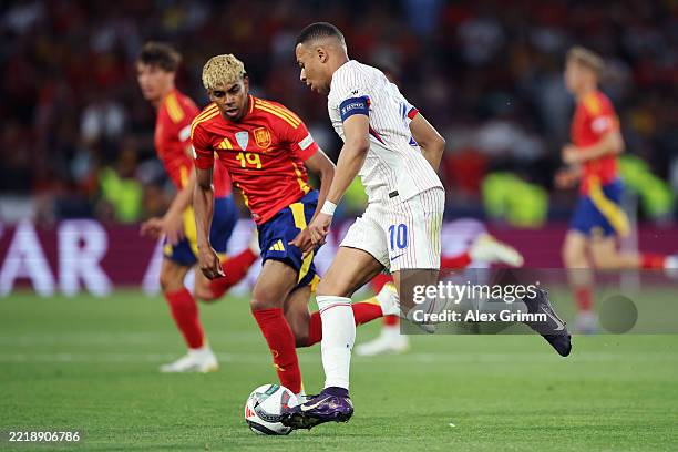 Kylian Mbappe of France is challenged by Lamine Yamal of Spain during the UEFA Nations League 2025 semifinal match between Spain and France at...