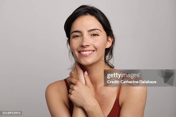 beauty portrait of a brunette beautiful smiling woman posing in front of a neutral background - studio photo - brown hair stock pictures, royalty-free photos & images