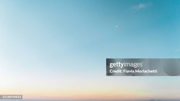 blue sunset sky with moon - clear sky stock pictures, royalty-free photos & images