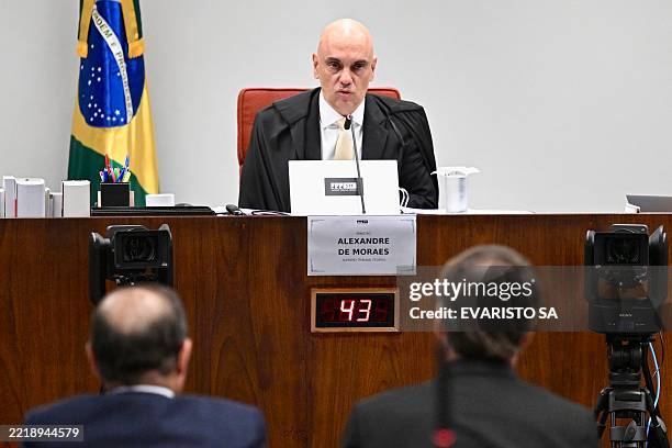 Former Brazilian President Jair Bolsonaro , sitting next to his lawyer Celso Villardi , takes the stand before judge Alexandre de Moraes during a...