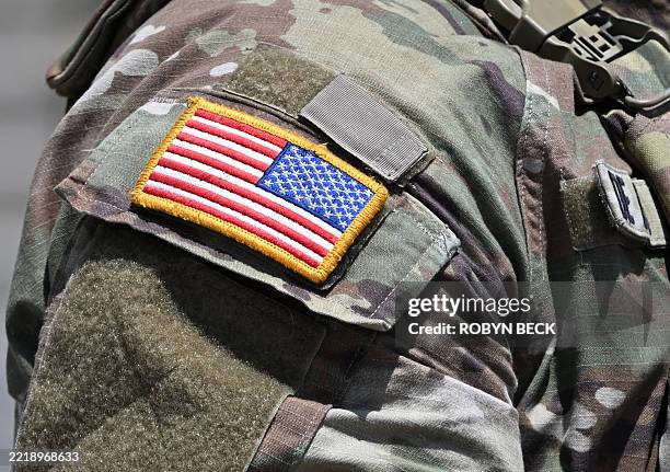 Close up of the US flag on the uniform of a California National Guard stationed outside the federal building in downtown Los Angeles, California on...