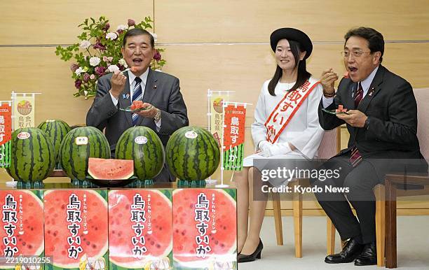 Japanese Prime Minister Shigeru Ishiba and economic revitalization minister Ryosei Akazawa eat watermelon produced from Tottori Prefecture at the...