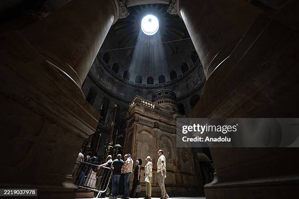 Christians light candles and pray at the Church of the Resurrection in Jerusalem, where Jesus Christ is believed to have been crucified, in June 11,...