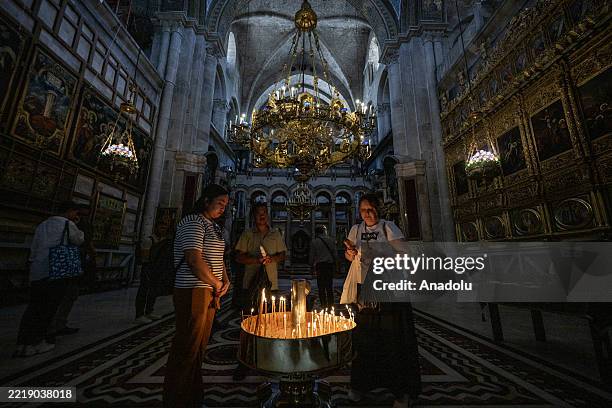 Christians light candles and pray at the Church of the Resurrection in Jerusalem, where Jesus Christ is believed to have been crucified, in June 11,...