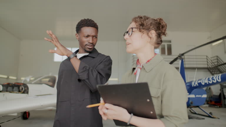 https://media.gettyimages.com/id/2219067388/video/mechanic-and-engineer-discussing-aircraft-maintenance-in-hangar.jpg?b=1&s=640x640&k=20&c=ObxVAwhmKCzxY3b6gK9F4r70nJzWDu0lXOgG3IcjFpI=