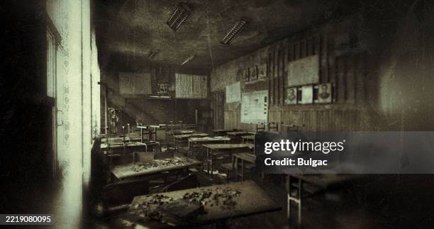 abandoned classroom with dusty desks and faded posters - abandoned school stock pictures, royalty-free photos & images