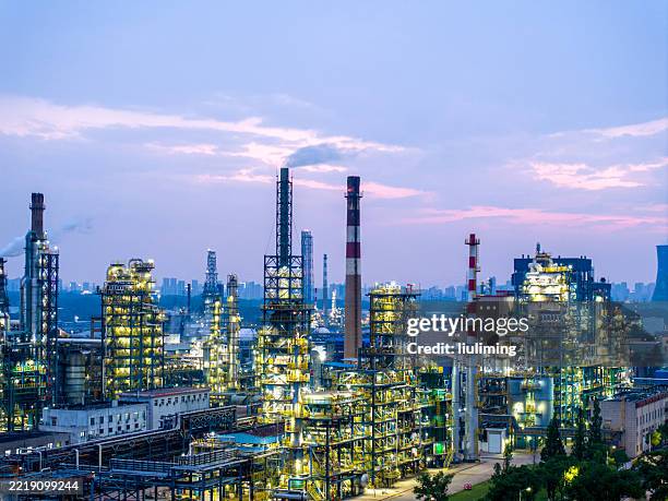 oil refineries and petrochemical plants photographed by a drone at dusk. - fuel storage tank stock pictures, royalty-free photos & images