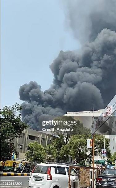 Smoke rises after a plane crash shortly after takeoff from Sardar Vallabhbhai Patel International Airport in India's western state of Gujarat on June...