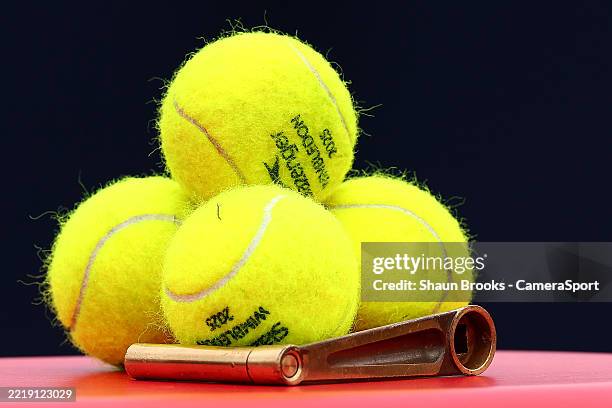 Wimbledon tennis balls sit ready on the Queens Club practice court at The Queen's Club on June 12, 2025 in London, England.
