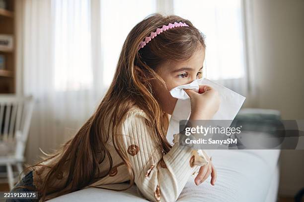 sick girl with tissues - cough tissue stock pictures, royalty-free photos & images