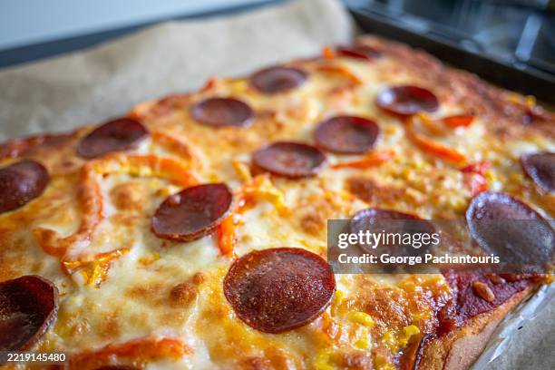 home made pizza with pepperoni on backing tray - rectangle pizza stock pictures, royalty-free photos & images