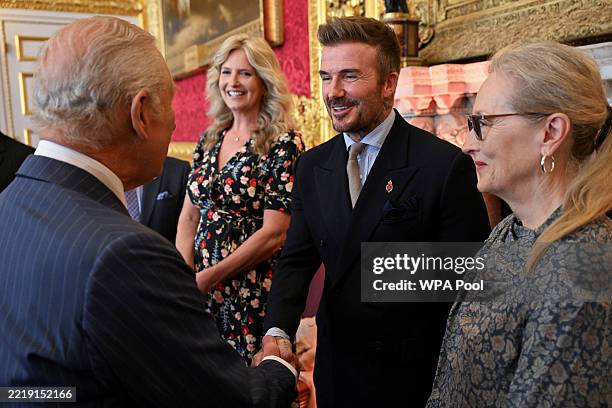 David Beckham shakes hands with Britain's King Charles III, next to Meryl Streep, as they attend the King's Foundation Awards ceremony, on the 35th...
