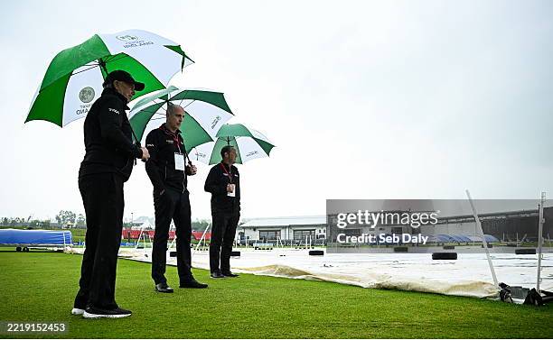 Tyrone , United Kingdom - 12 June 2025; Umpires, from left, Mark Hawthorne, Roly Black and Aidan Seaver inspect the covers before match one of the...