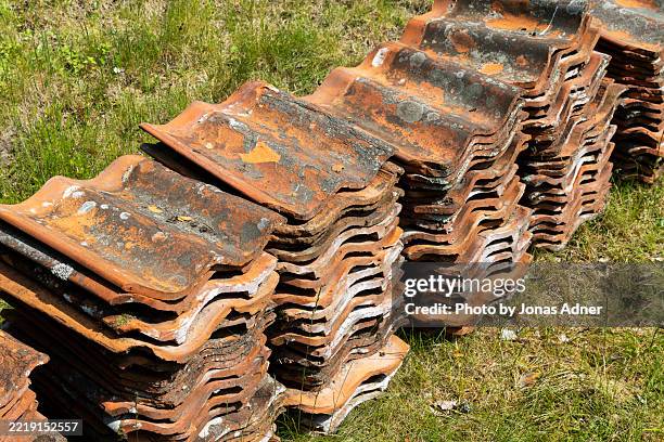 piles of old roof tiles - roof tile stock pictures, royalty-free photos & images