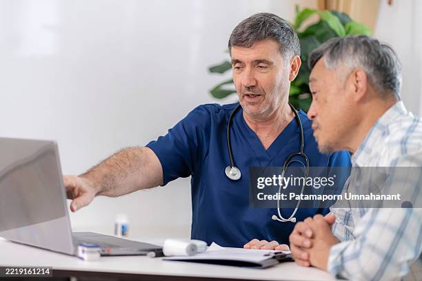 compassionate medical expert speaks with senior adult, documenting symptoms on a laptop. a moment of trust, empathy, and responsibility in geriatric care. focused on healthcare, domestic life, illness management, and emotional support. - drug side effects stock pictures, royalty-free photos & images
