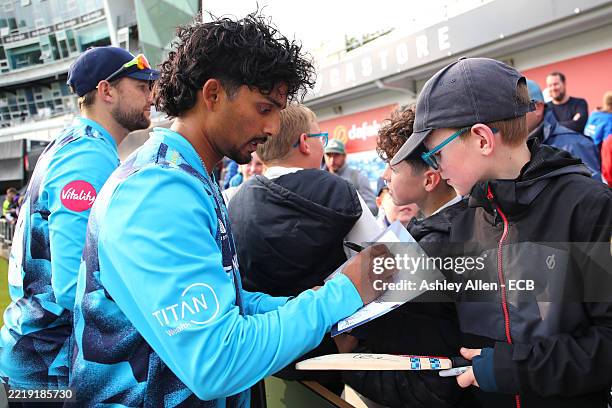Jafer Chohan of Yorkshire signs autographs after the Vitality Blast Men's T20 match between Yorkshire and Leicestershire Foxes at Headingley on June...