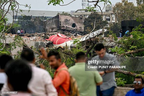 Debris of Air India flight 171 is pictured after it crashed in a residential area near the airport in Ahmedabad on June 13, 2025. Rescue teams with...