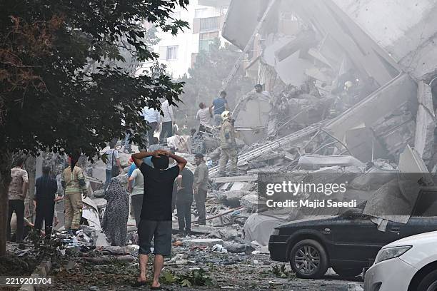 People look over damage to buildings in Nobonyad Square following Israeli airstrikes on June 13, 2025 in Tehran, Iran. Iran's three top military...