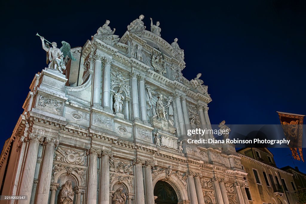 View of the illuminated top of the highly decorated Chiesa di Santa Maria del Giglio at night, Venice, Italy