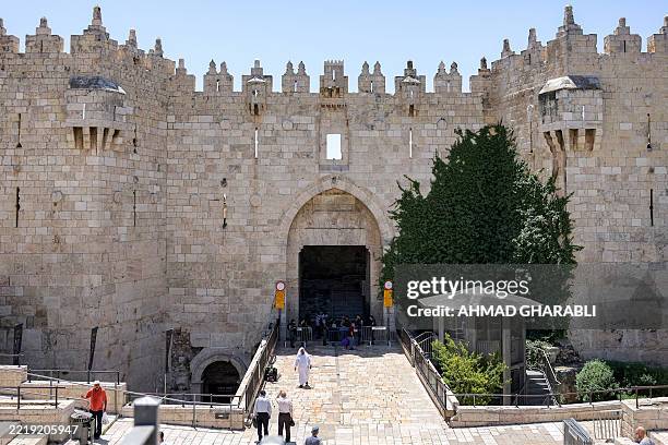 Israeli security forces stand outside the empty Damascus Gate of the old city walls of Jerusalem on June 13, 2025.