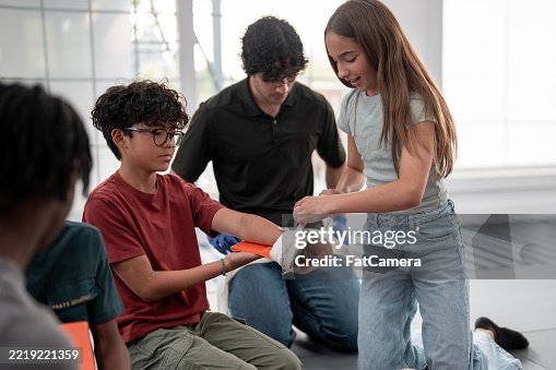 Teenagers Learning First Aid Techniques in a Hands-On Training Session Teenagers Learning First Aid Techniques in a Hands-On Training Session