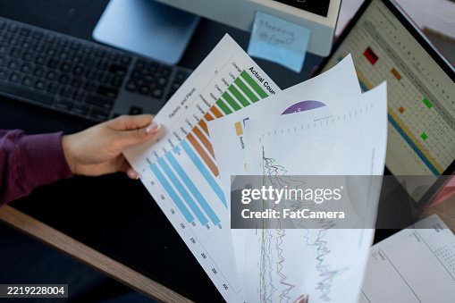 Professional Analyzing Graphical Data in a Modern Office Setting Professional Analyzing Graphical Data in a Modern Office Setting